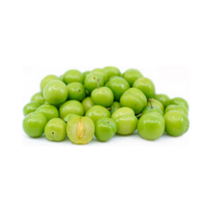 A large heap of fresh, bright green sour plums (Goje Sabz) on a white background, with one plum sliced in half in the foreground to show the translucent green flesh and small central pit.