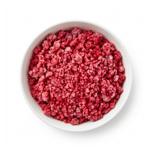 A pile of dark red Frozen Raspberry Crumbles with broken pieces and frosted IQF surface on a white background.