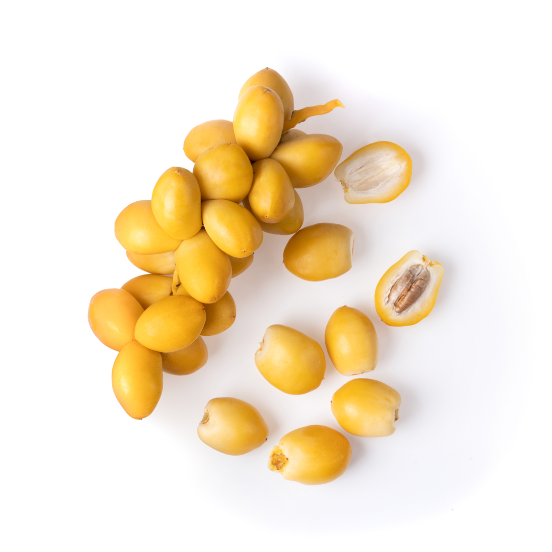 A pile of bright yellow fresh Khalal-stage dates with crisp firm skin and small tan tips on a white background.